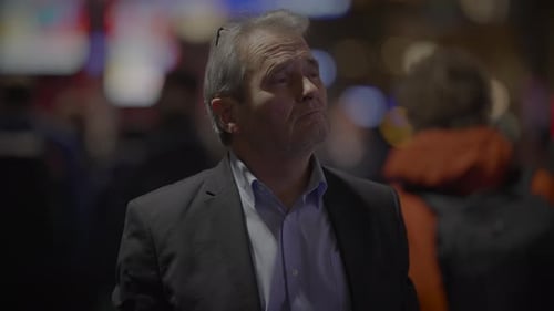 Man Observes City Lights at Night