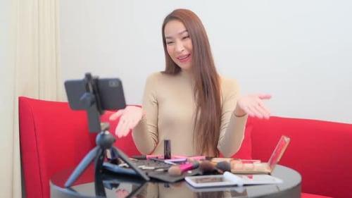 Enthusiastic Woman Vlogging About Makeup at Home