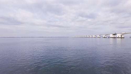 drone flight over the bank of the eastern scheldt in the netherlands over water towards the huge ze