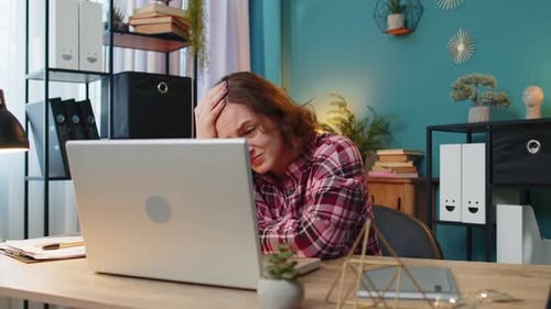 Displeased Sad Woman Using Working on Laptop Loss Game Fail Computer Virus at Home Office Table