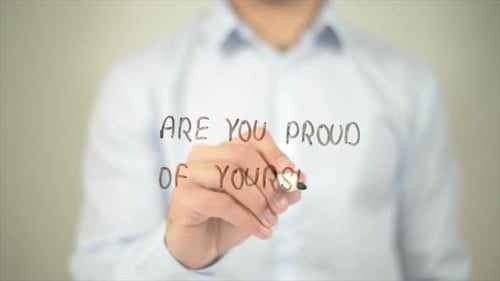 Person Writing Message on Clear Surface