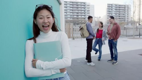 Headshot of Young Friendly Asian Student Woman Smiling at Camera at Campus