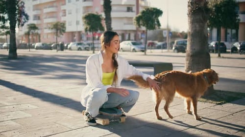 Happy Skater Stroking Dog Resting Summer Street Carefree Girl Enjoying Vacation