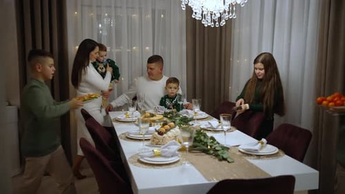 Family Gathers Around Table in Cozy Home for Meal