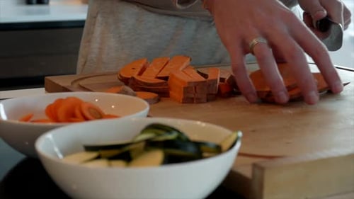 4k camera footage. Cooking vegetables. Eating healthy at home. Chopping and cooking carrot, zucchini
