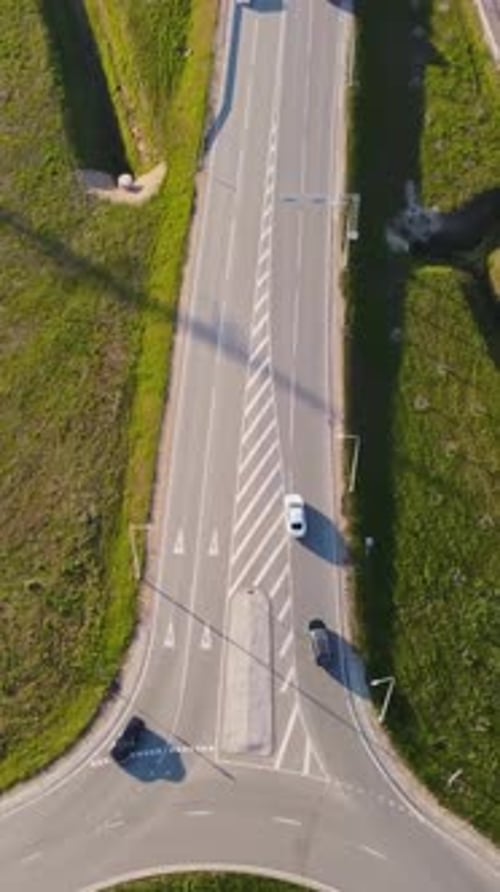Vertical drone flies over Katlakalns interchange where Daugmale road meets roundabout with signs