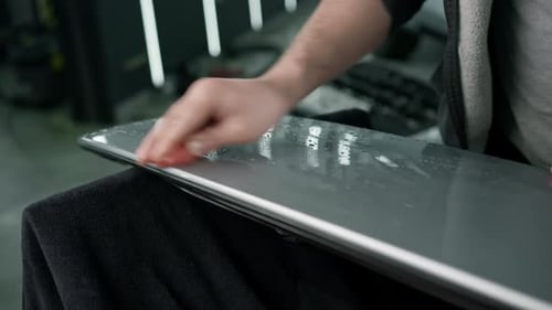 Adult Hand Carefully Working on a Gray Surface