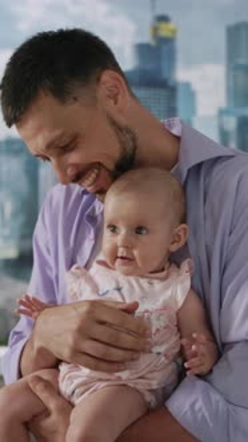 Loving Father Holding Adorable Baby Daughter in Apartment
