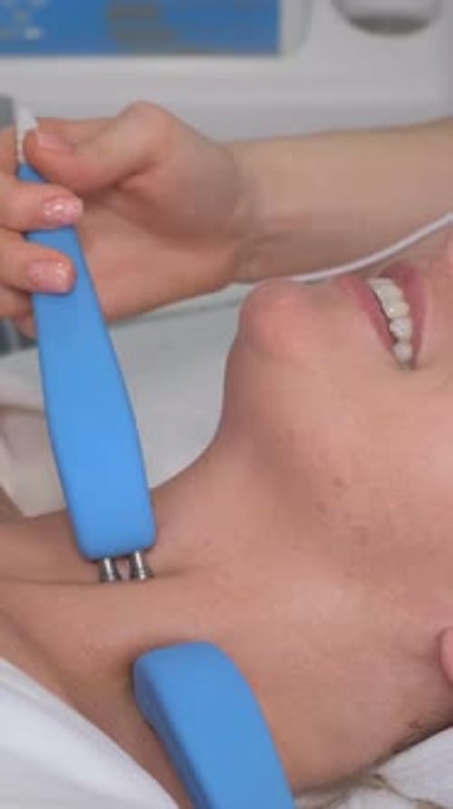 Woman Receiving Neck Treatment at Clinic
