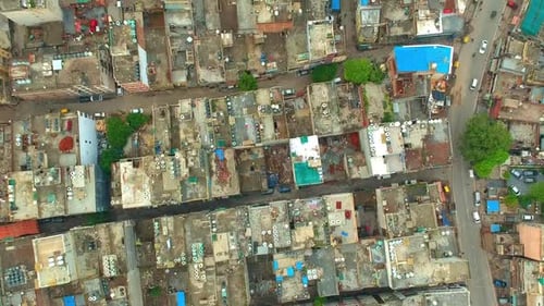 Cars Driving On The Street With Rooftops Of Crowded Residential Buildings In New Delhi, India. - aer