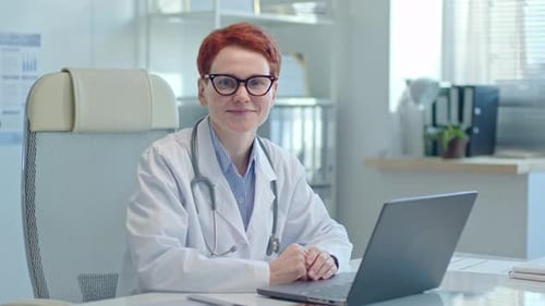 Portrait of Female Doctor Working on Laptop in Medical Office