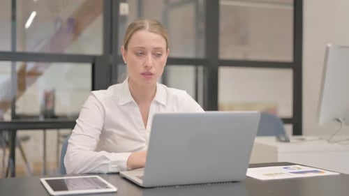 Mature Business Woman Doing Video Chat in Office