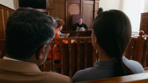 Jury Discussing Case During Trial on Young Red-Haired Inmate in courtroom
