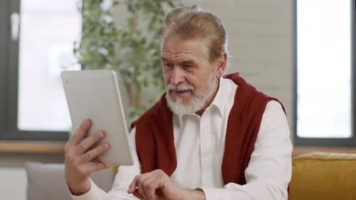 Senior Man Using Tablet Indoors During Daytime