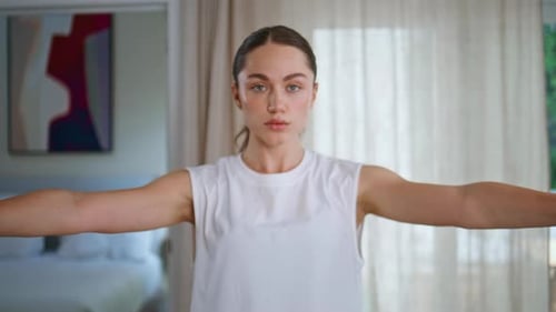 Young Woman Does Arm Workout with Dumbbells