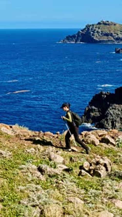 Hiker on Rocky Coastline with Stunning Ocean Views
