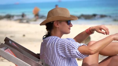 Woman Relaxing On Sunbed On Exotic Beach, Super Slow Motion