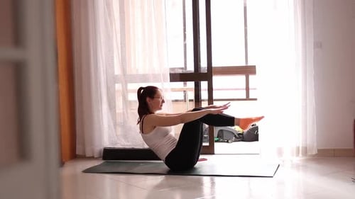 Woman Doing Core Exercise on Yoga Mat