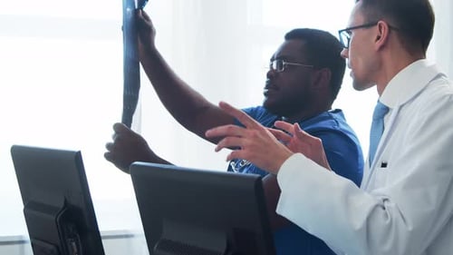 Doctor and Surgeon Talking Near Window Medical Workers in Hospital Office Day Light Healthcare