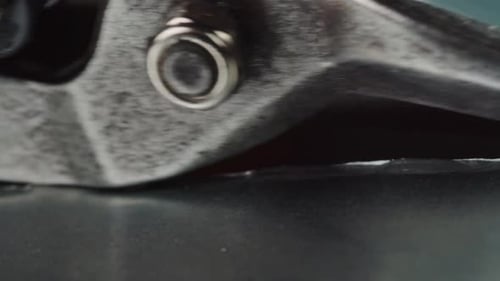 Hände eines Technikers, der mit einer harten Schere ein Blatt schneidet, Nahaufnahme