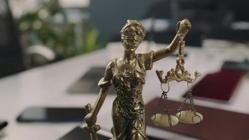 Statue of Goddess Themis with Scales and Sword in Lawyers Office