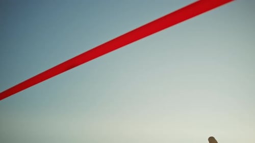 Beautiful Fit Female Runner Crossing the Finish Line on a Professional Sports Arena. Athletic Woman