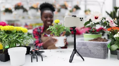 Woman Making Gardening Tutorial Video in Greenhouse