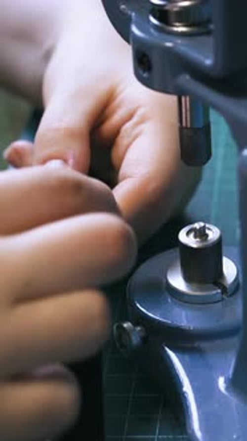 Crafting Eyelets: Securing Fabric with a Hand Press