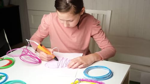 Girl Drawing with a 3D Printing Pen Indoors