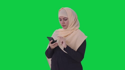 Muslim woman using a phone Green screen