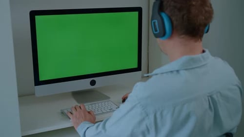 Adult Using Desktop Computer with Green Screen