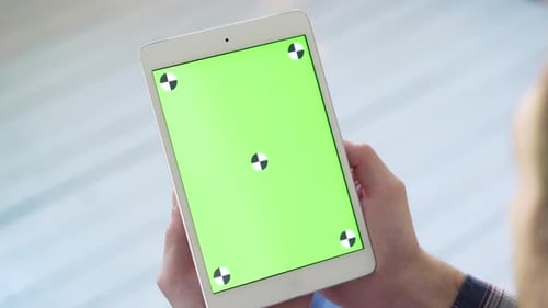 Man Using Tablet PC with Green Screen