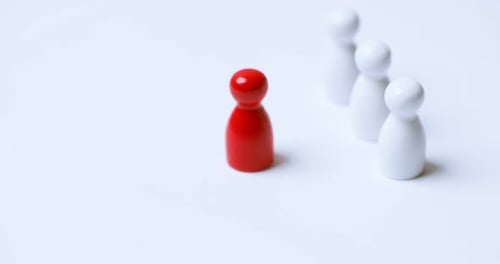 Red Game Piece Standing Out From White