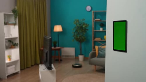 Focus on Wall Tablet with Chroma Key Green Screen Man Touching Display Switching on House Gadgets
