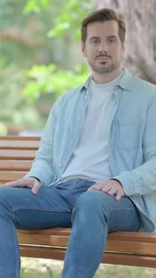 Man Sitting on Bench Outdoors