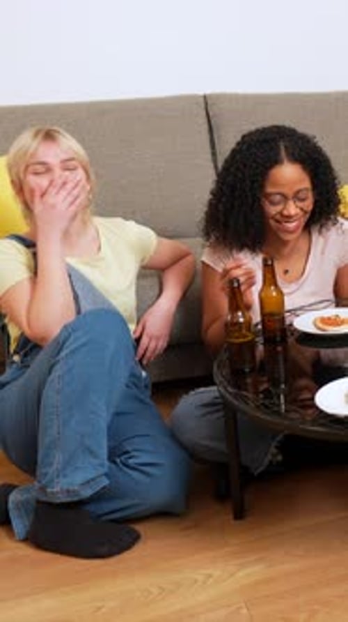 Friends Sharing Laughter Pizza and Beer at Home