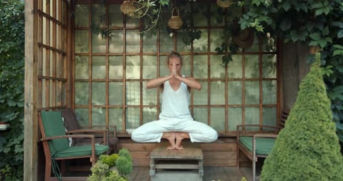 Adult Man Doing Yoga Outdoors in Garden