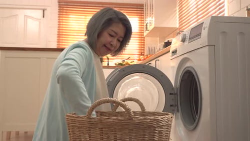 Senior Woman Doing Laundry at Home