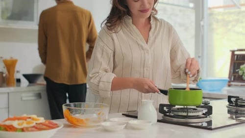 Woman Cooking Delicious Food in Bright Kitchen