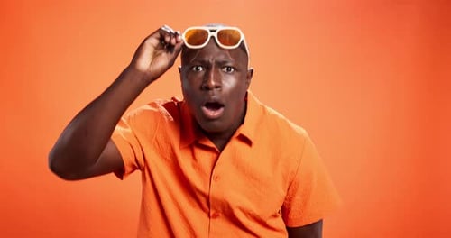 Black man, sunglasses and surprise with face in studio with questions, confused