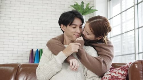 Loving Couple Embracing on Couch