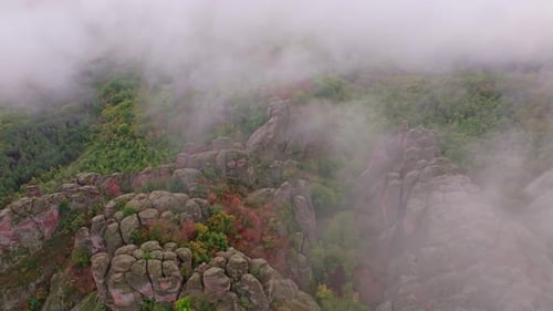 Aerial view of autumn mist over rocks and forest, Bulgaria.