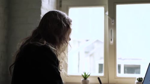 Young Woman Working on Her Laptop Computer in Coffee Shop