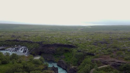 Aerial View of Volcanic Plateau With Waterfall and Green Lava Fields Iceland