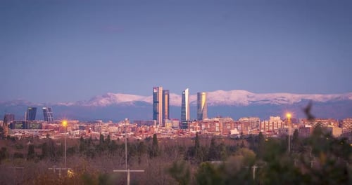 Night to day Timelapse of Madrid skyline. Beautiful sunrise and alpenglow in the mountains behind th