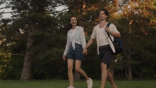 Couple Holding Hands Walking Through Park