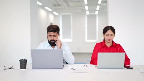 Focused Indian Professionals Working in Modern Office