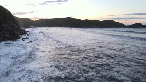 Majestic Lake Surrounded By Towering Mountains Under a Vast Sky