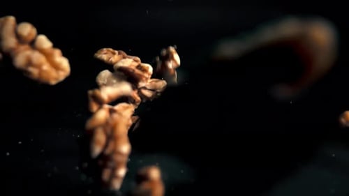 Walnuts Falling in Slow Motion on Black Background