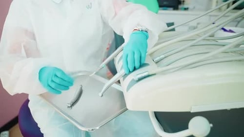 Stomatologist Preparing Equipment and Tools for Patient Appointment in Dental Clinic Closeup